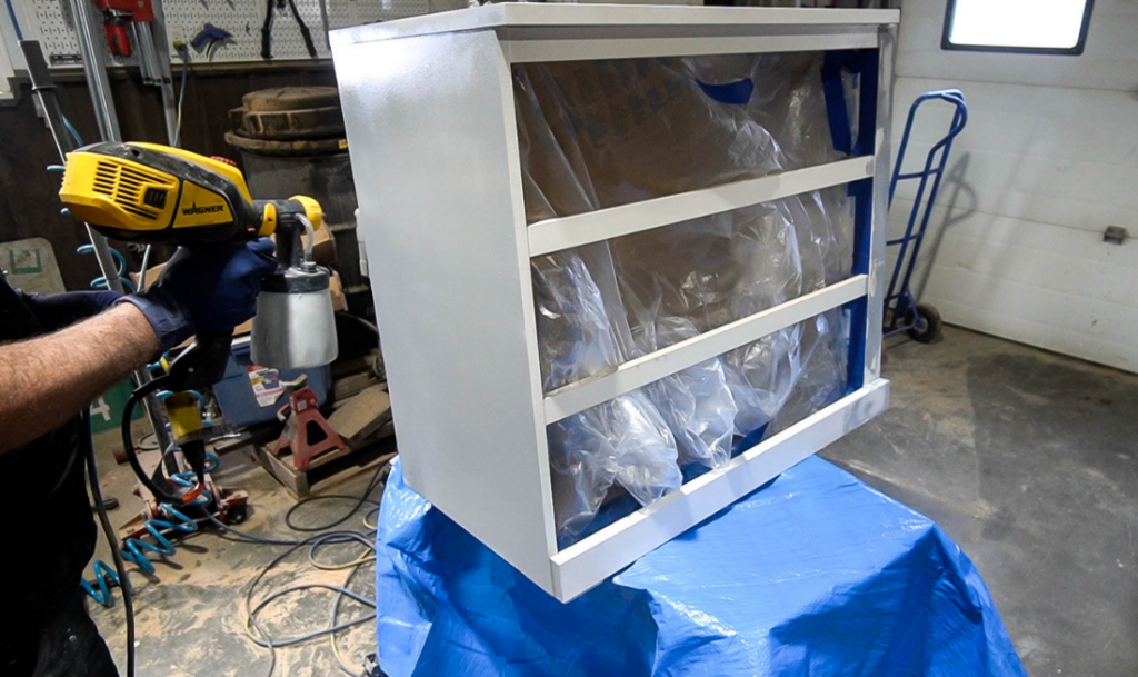 painting a cabinet with a Wagner Flexio 3500 paint sprayer with white paint