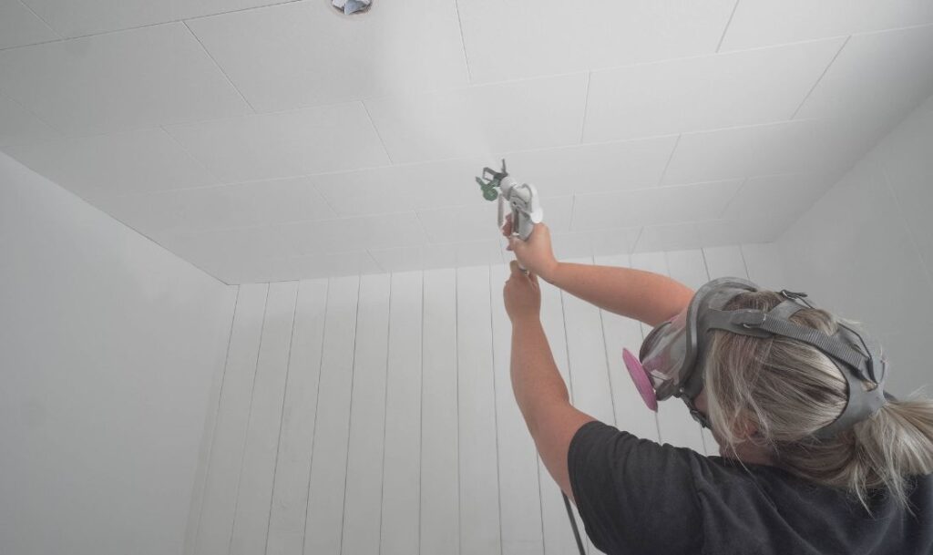 spraying paint on ceiling with Control Pro 130 paint sprayer