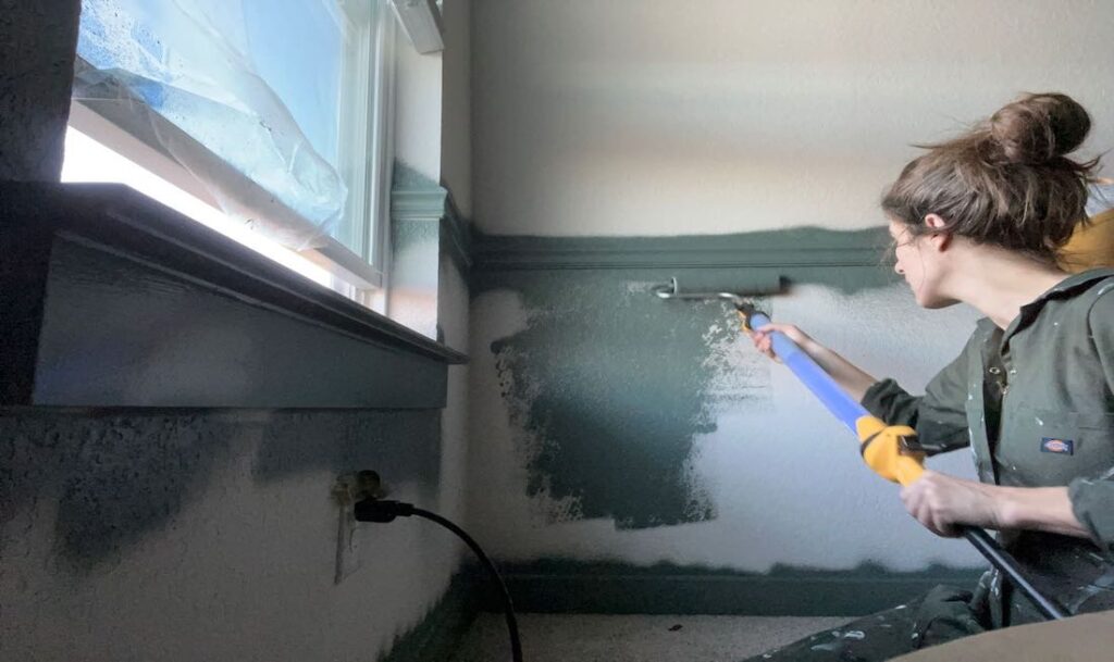 person using the PaintStick EZ Roller to apply paint to their bedroom walls
