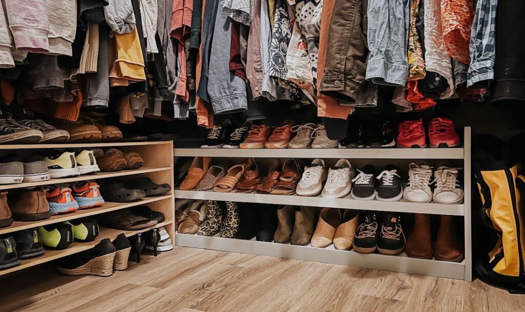 closet inside of a house with a piece of furniture that holds all of the shoes in pairs. Furniture was painted in the garage with a large spray shelter and a flexio paint sprayer