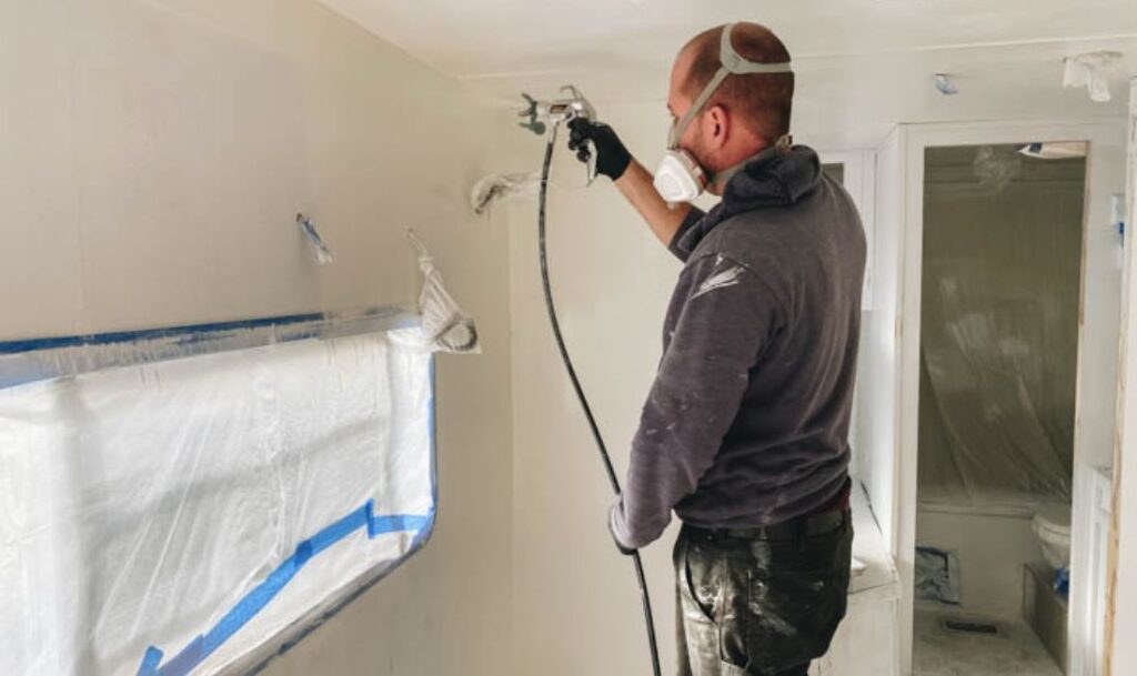 person paint spraying the inside of an RV with the Wagner Control Pro HEA 170 sprayer
