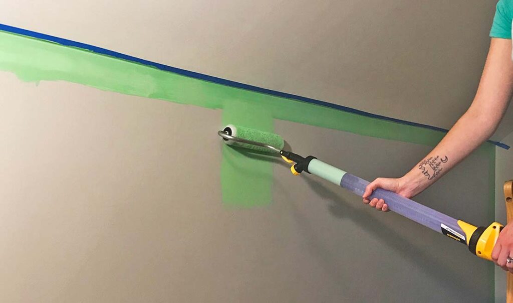painting with PaintStick EZ Roller on the wall, green paint