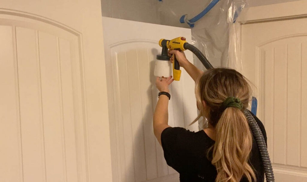a person painting kitchen cabinets with the FLEXiO 5000 paint sprayer