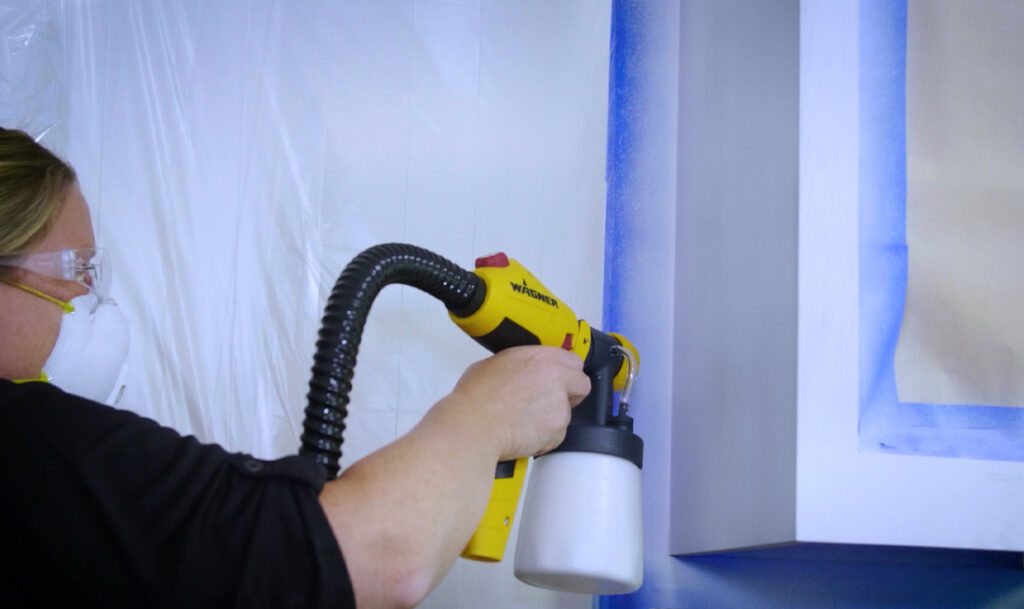 close up of spraying kitchen cabinets