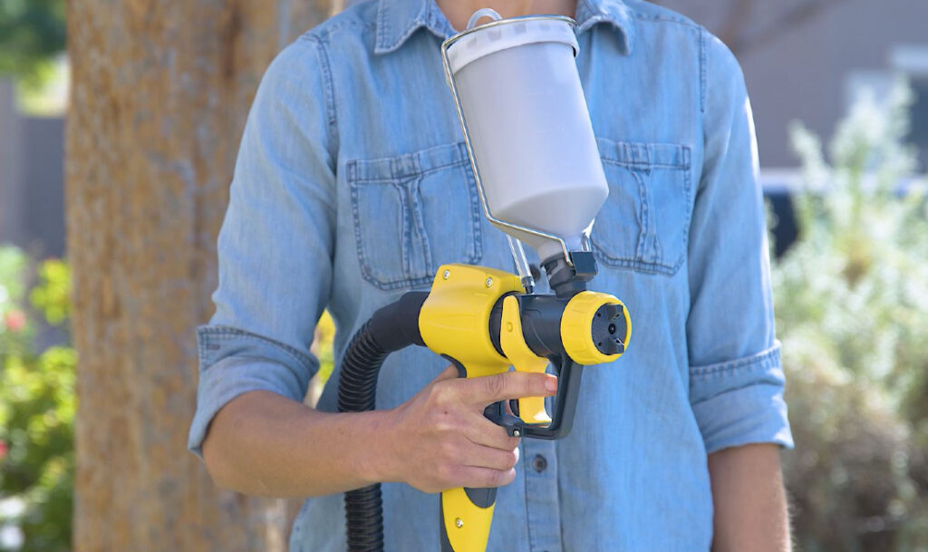 woman holding wagner sprayer 