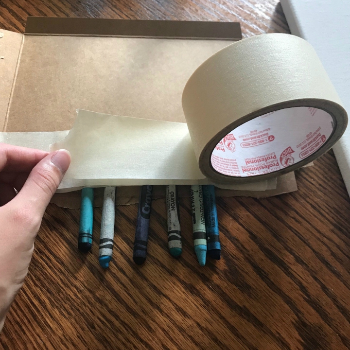 Tape crayons to melting surface