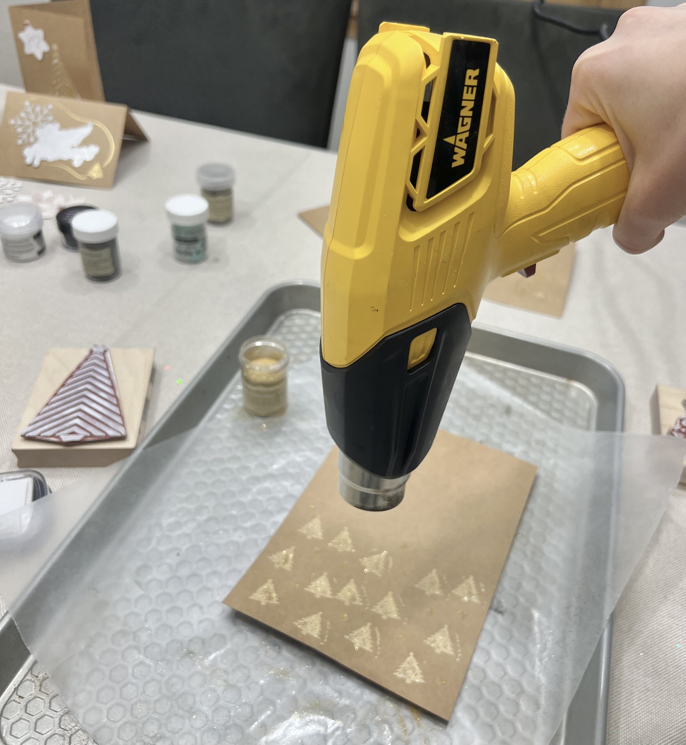 Embossing mini Christmas trees with a Wagner heat gun