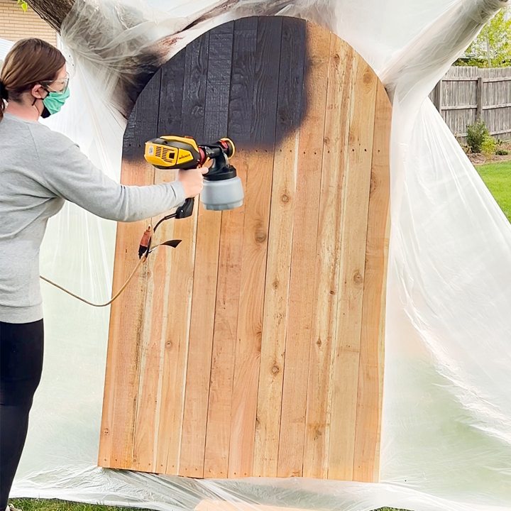 WAGNER spraying the stain on the gate
